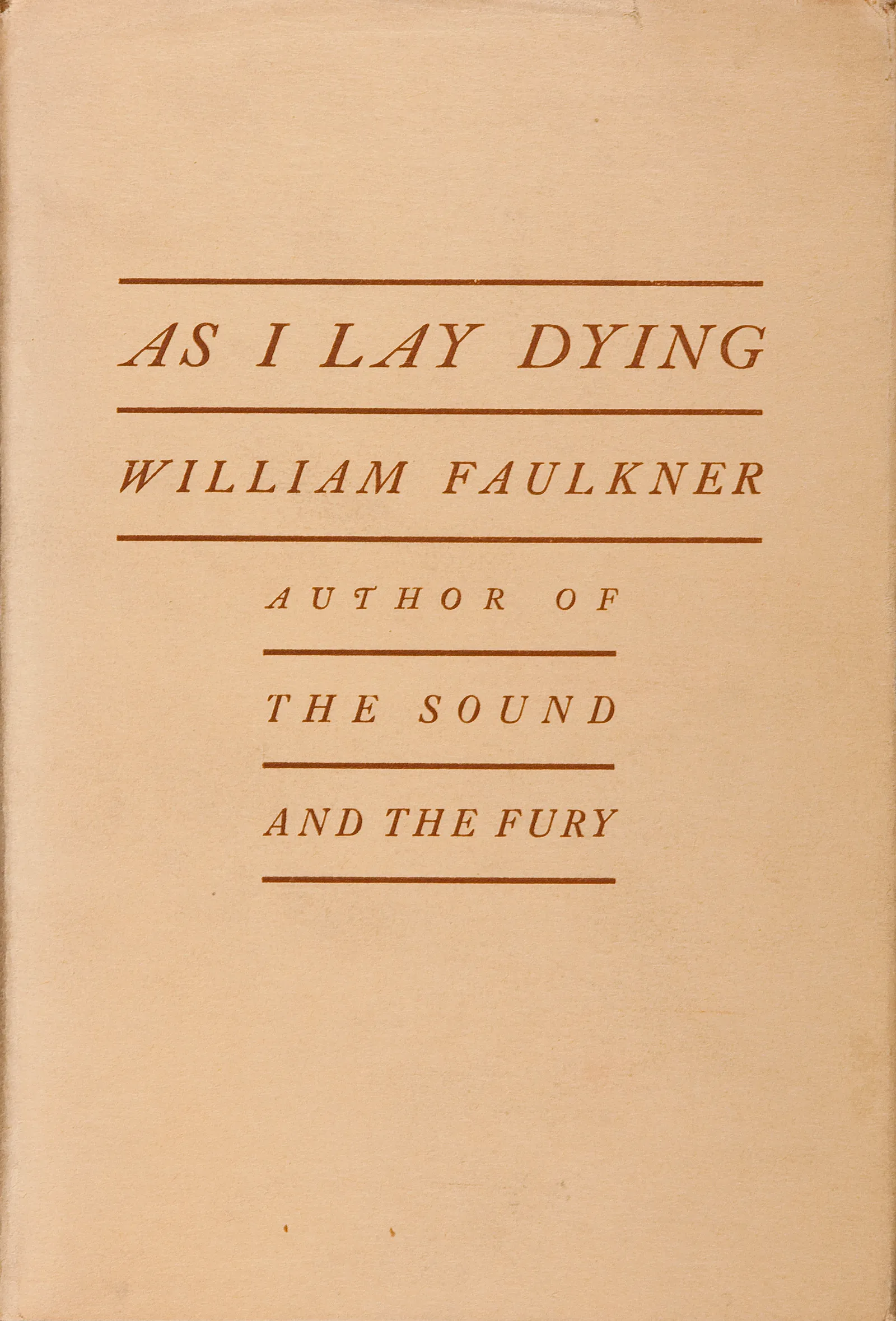 Beige dust jacket of the first edition of As I Lay Dying, with the title and William Faulkner's name in brown capitals between rules.